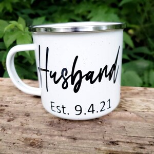 May include: White enamel mug with black lettering that reads "Husband Est. 9.4.21".