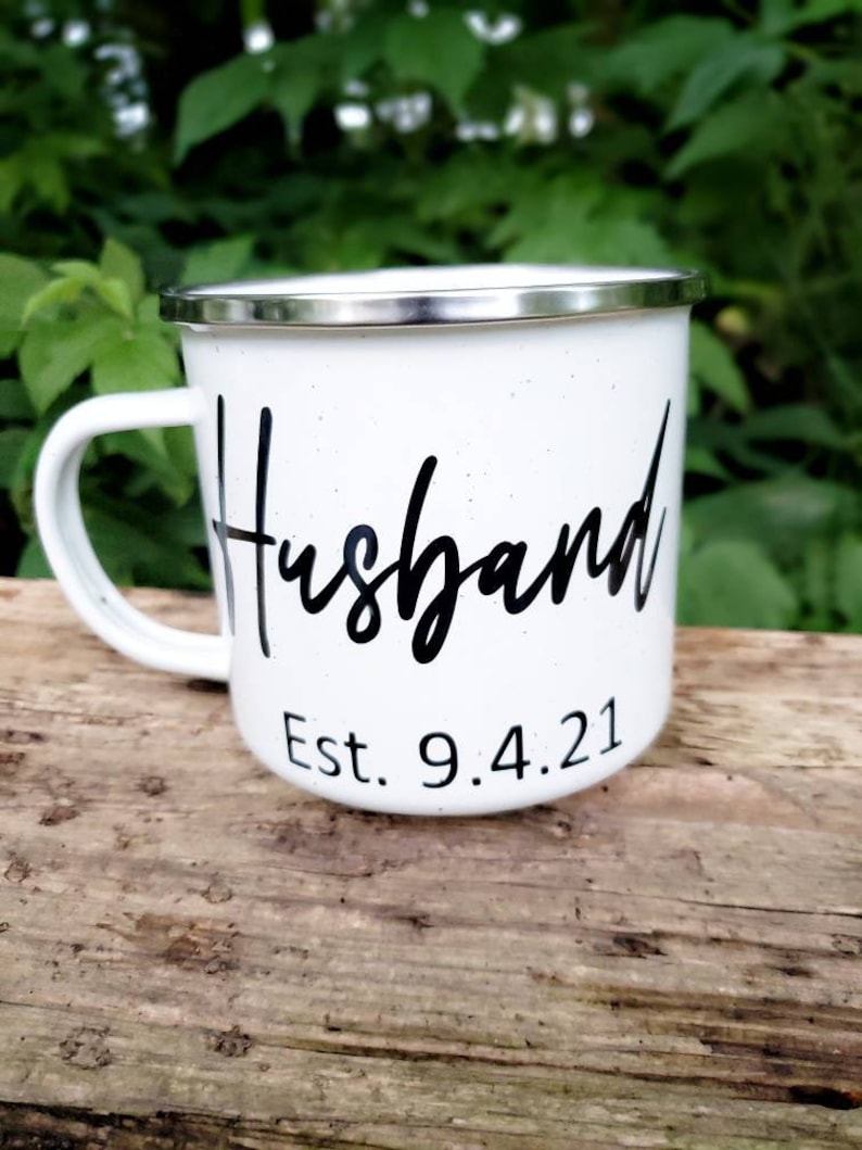 May include: White enamel mug with black lettering that reads "Husband Est. 9.4.21".