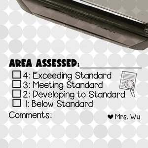 May include: A black and white stamp with a cartoon image of a woman with a thumbs up. The stamp says "mrs. wu likes this!" and has a white background. Below the stamp is a checklist with the text "AREA ASSESSED:" and four options: "Exceeding Standard", "Meeting Standard", "Developing to Standard", and "Below Standard". There is a small, blue circle with a pineapple and the text "A Small World Called kindergarten".