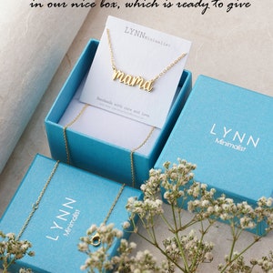 May include: A gold necklace with the word "mama" on it, packaged in a light blue box with the brand name "LYNN Minimalist" printed on it.