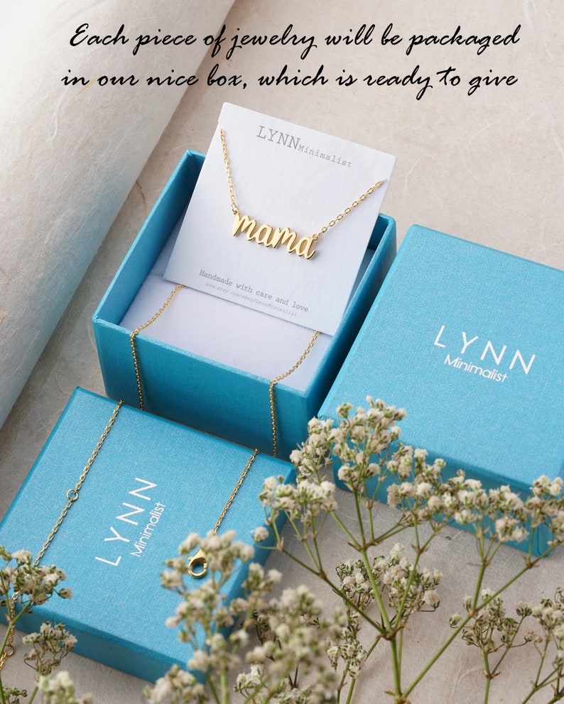 May include: A gold necklace with the word "mama" on it, packaged in a light blue box with the brand name "LYNN Minimalist" printed on it.
