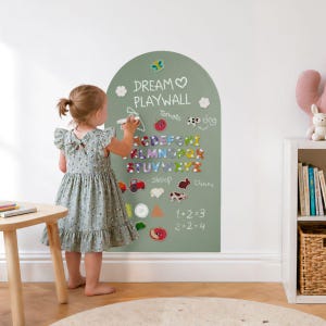 May include: An arched sage green wall decal chalkboard featuring the text DREAM PLAYWALL, a colorful alphabet, and various illustrations including a tractor, animals, and math equations. The surface is decorated with small flower and butterfly accents.