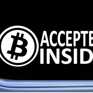 May include: A white sticker with a Bitcoin symbol and the text "ACCEPTED INSIDE" on a black background.