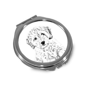 May include: A silver compact mirror with a black and white illustration of a small, fluffy dog with curly hair. The dog is looking at the viewer.