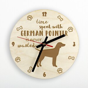 May include: A wooden clock with a brown German Pointer silhouette and the text "time spent with German Pointer is never wasted". The clock face has paw prints and bone designs around the edge.