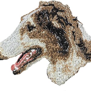 May include: Embroidered patch of a brown and white dog's head with its mouth open. The dog has black eyes and a black nose.