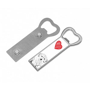 May include: A silver bottle opener with a heart-shaped opening and a white rectangular panel featuring a black and white image of a dog and a red heart. The panel is attached to the bottle opener.