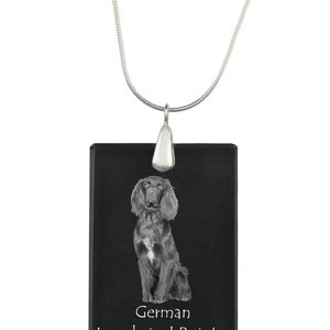 May include: A silver chain necklace with a black rectangular pendant featuring a German Longhaired Pointer dog. The pendant has the words "German Longhaired Pointer" printed on it.