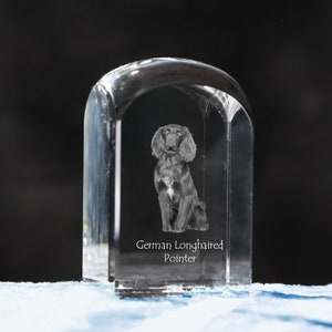 May include: A clear glass paperweight with a 3D engraved image of a German Longhaired Pointer dog. The text "German Longhaired Pointer" is engraved below the image.