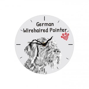 May include: A white clock with black hands and a black and white illustration of a German Wirehaired Pointer dog. The clock face also has the text "German Wirehaired Pointer" and a red heart with a paw print.