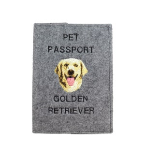 May include: Grey felt pet passport holder with embroidered text "PET PASSPORT" and "GOLDEN RETRIEVER". An embroidered image of a golden retriever dog is in the centre.