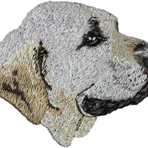 May include: Embroidered patch of a white Labrador Retriever dog's head, looking to the right. The dog's fur is white with brown markings around the ears and eyes.