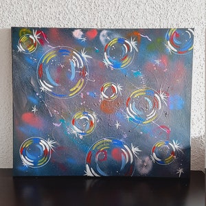 The hand-painted soap bubble artwork on a black background is a captivating representation that combines contrasts and luminosity. image 2