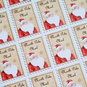May include: A sheet of 12 festive, white-bordered, red and gold Christmas stickers featuring a cartoon Santa Claus with the text "North Pole Mail".