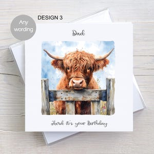 May include: A birthday card featuring a watercolour illustration of a Highland cow peeking over a wooden fence. The card has the text "Dad" and "Heard it's your birthday" on it.