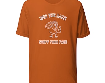 May include: Orange t-shirt with a white turkey graphic and the text "Run the Race Stuff Your Face".