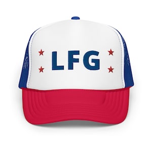 May include: A white and red trucker hat with a blue mesh back. The front of the hat has the letters "LF G" in blue with red stars on either side.