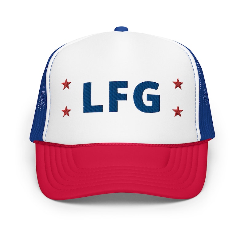 May include: A white and red trucker hat with a blue mesh back. The front of the hat has the letters "LF G" in blue with red stars on either side.