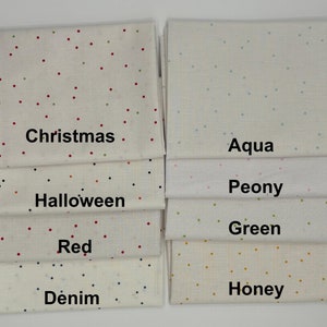 May include: A set of 10 fabric squares with different colored polka dots on a white background. The fabric squares are labeled with the following colors: Christmas, Aqua, Peony, Green, Honey, Red, Denim, Halloween.