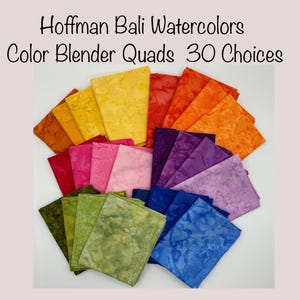 May include: A collection of 30 Hoffman Bali Watercolors Color Blender Quads fabric squares in various shades of yellow, orange, red, pink, purple, blue, and green. The fabric squares are arranged in a fan shape.