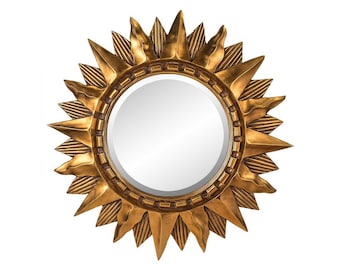 May include: A gold sunburst mirror with a round, reflective surface. The mirror has a decorative, textured frame with a starburst design.