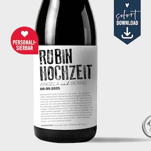Op de afbeelding: Een zwarte fles met een wit etiket met de woorden "RUBIN HOCHZEIT" en de namen "ANGELA en BERND" met de datum "09.09.2025". Het etiket bevat ook Duitse tekst. Een rood hart en het woord "PERSONALI-SIERBAR" staan links.