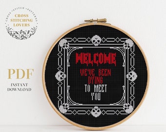 May include: Black and white cross stitch pattern with a skull border and the text "Welcome We've Been Dying To Meet You".
