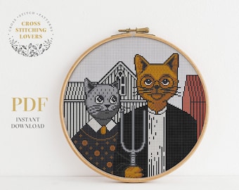 May include: Cross stitch pattern featuring two cats in a portrait style. The cat on the left is gray and the cat on the right is orange with glasses. The pattern is in a round hoop.