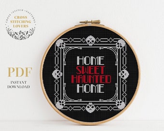 May include: Black and white cross stitch pattern with a black background and white text that reads "Home Sweet Haunted Home". The text is surrounded by a decorative border with skulls.
