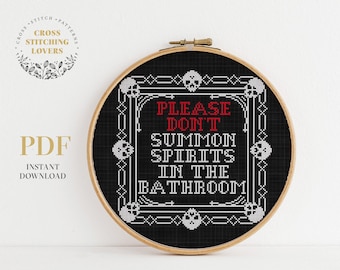 May include: Black and white cross stitch pattern with a black frame and the text "Please Don't Summon Spirits In The Bathroom".