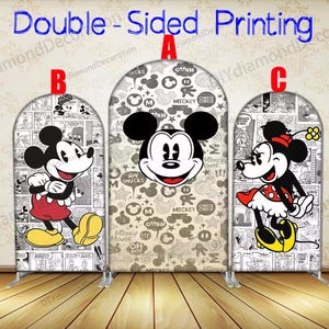 May include: Three arched backdrop displays featuring Mickey and Minnie Mouse. The centre display has Mickey's face on a grey background with cartoon elements. The side displays show Mickey and Minnie in classic poses against a comic strip background. The text "Double-Sided Printing" is at the top.