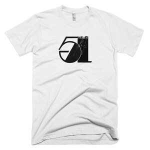 May include: White t-shirt with a black graphic of the number 51 with the word "AREA" above it. The graphic has a distressed look.