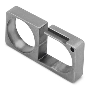 May include: A contemporary ring with a matte, gunmetal grey finish. The ring's design features two square shapes linked by a small rectangular bridge. One square has a circular opening, the other a small drilled hole.