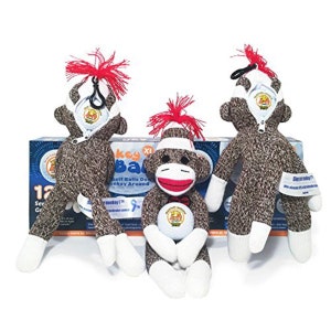 May include: Three sock monkey golf ball holders. The monkeys are wearing white bandages and have red hair. One monkey is holding a white golf ball. The monkeys are sitting in front of a box that says "Monkey Balls Golf Balls Done Monkey Around".