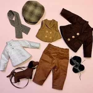 May include: A collection of doll clothing including a plaid flat cap, a black and white checkered scarf, a light grey honeycomb-patterned long-sleeve shirt, a tan double-breasted waistcoat, a brown jacket with buttons, brown trousers, and black shoes.