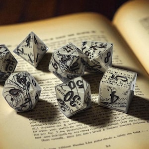 Puede incluir: Un conjunto de siete dados poliédricos con un diseño de periódico vintage, colocados sobre las páginas abiertas de un libro antiguo. Los dados tienen varias formas, incluyendo un d4, d6, d8, d10, d12 y d20. Las páginas del libro están envejecidas.