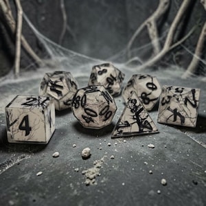 May include: A set of seven ivory-colored polyhedral dice with black vein-like patterns and numbers. The dice include a D4, D6, D8, D10, D12, D20, and a percentile die. The dice are arranged on a dark, textured surface.