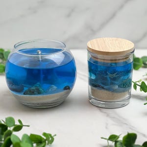 Handmade nautical blue gel candle with cotton wick and with sand and shells with beach bum scent