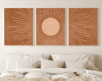May include: Three framed prints with a minimalist design featuring a sun with rays in a burnt orange color on a brown background.