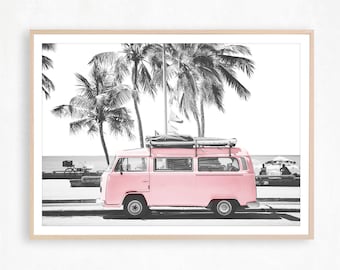 May include: A pink vintage van with a surfboard on the roof parked in front of palm trees on a beach.