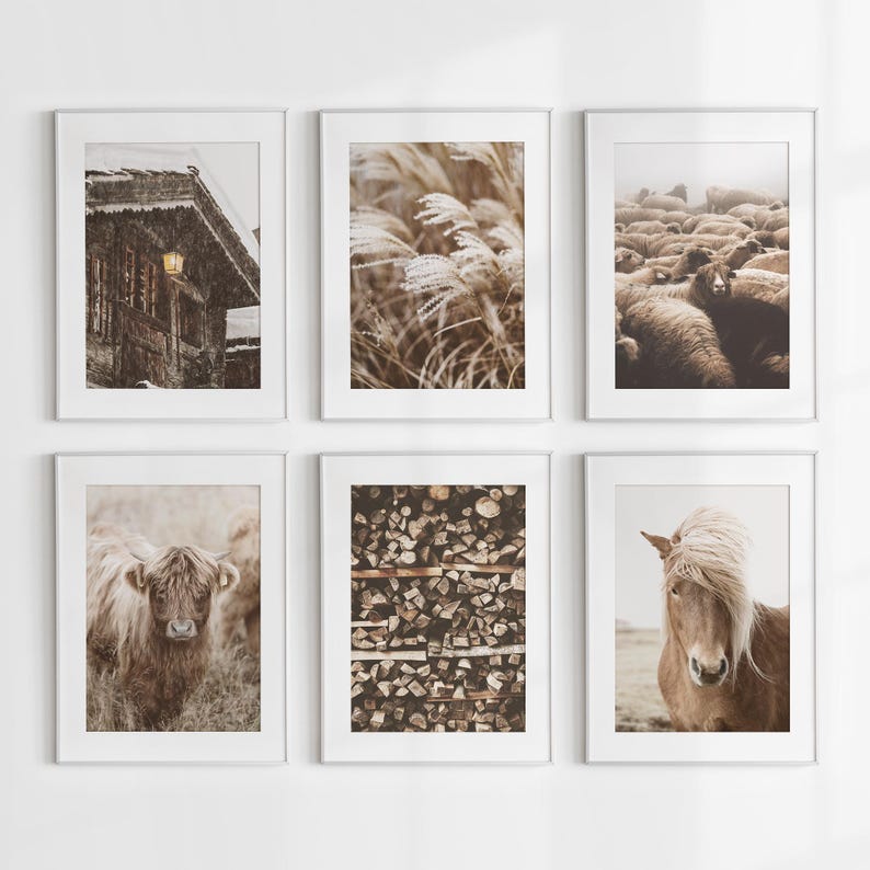 May include: Set of six framed art prints featuring nature scenes. Includes a snowy cabin, tall grass, a flock of sheep, a Highland cow, a stack of firewood, and a horse with a long mane. The prints are in neutral tones.