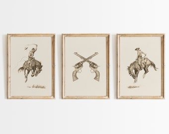 May include: Three framed prints with a western theme. The left and right prints feature a cowboy riding a bucking horse. The center print features two crossed revolvers.