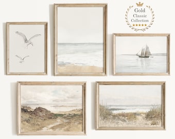 May include: Set of five framed watercolor paintings depicting seascapes. The paintings feature a sailboat, seagulls, and a beach scene.
