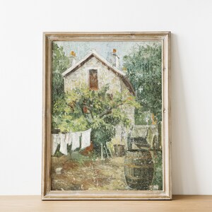 May include: A framed oil painting depicting a stone house with a window and a tree in front of it. The house is surrounded by greenery and there is a barrel in the foreground.