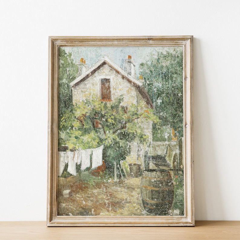 May include: A framed oil painting depicting a stone house with a window and a tree in front of it. The house is surrounded by greenery and there is a barrel in the foreground.