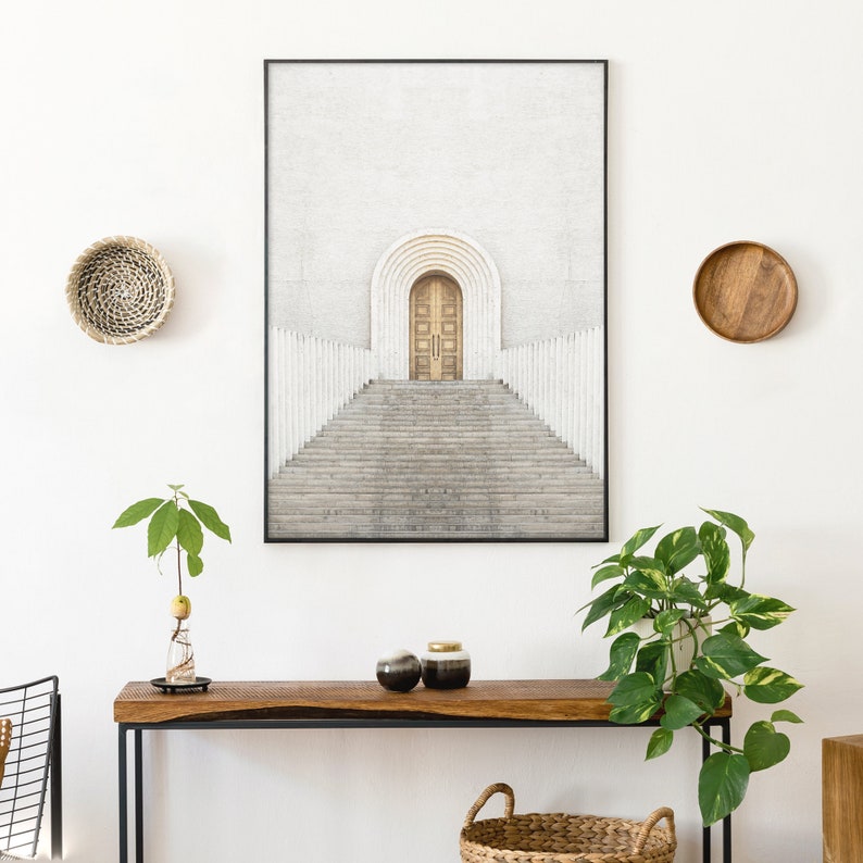 May include: A black framed print of a white building with a large arched doorway and steps leading up to it. The building is set against a white background.