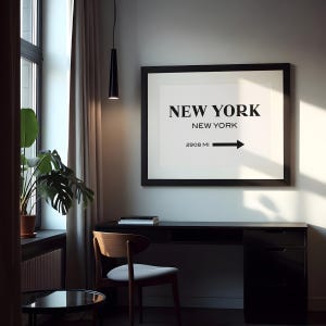 May include: A framed wall art print featuring the text NEW YORK in large bold letters, followed by NEW YORK in smaller text, and 2908 MI with a right-pointing arrow. The print is displayed in a black frame against a light-colored wall.