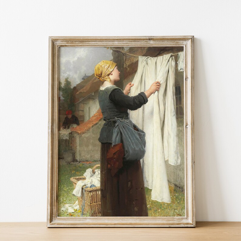 May include: A painting of a woman in a yellow headscarf hanging laundry outside. She is standing in a courtyard with a basket of laundry and a building in the background.