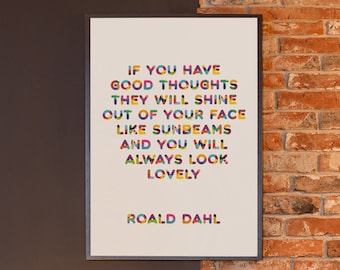 May include: A framed quote by Roald Dahl, "If you have good thoughts they will shine out of your face like sunbeams and you will always look lovely." The quote is printed in colourful letters on a white background. The frame is hanging on a brick wall next to a black wall with a black metal lamp and stool.