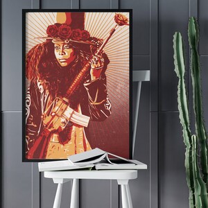 May include: A red and orange poster featuring a woman wearing a black hat with red roses and a black jacket holding a rifle. The background is a red and orange sunburst.